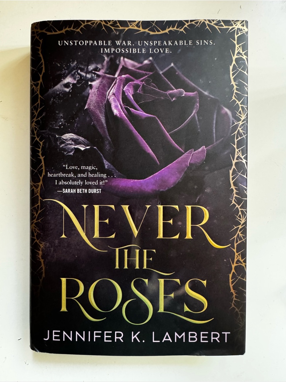 Never the Roses by Jennifer K Lambert — Hardcover Book in Purple